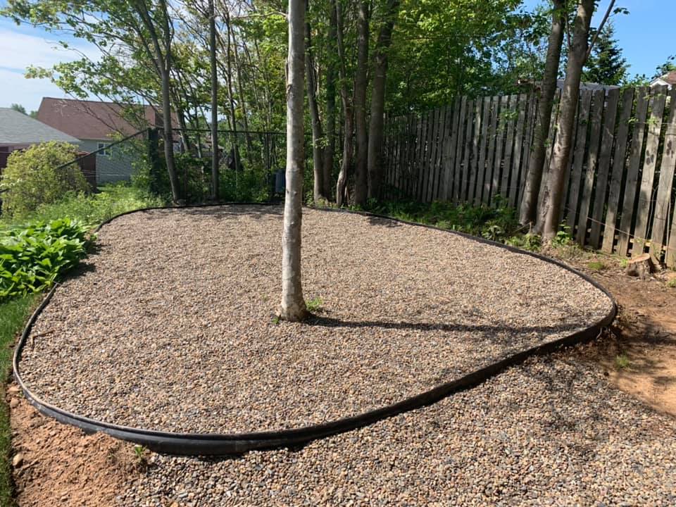 Gravel play area surrounded by trees
